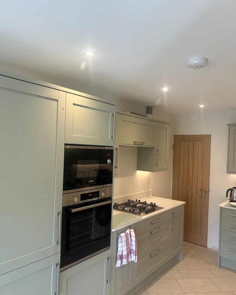 Completed kitchen installation by IP Electrical with recessed downlights and under-cabinet lighting
