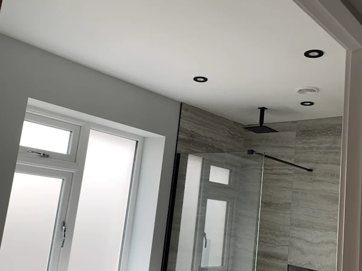 Bathroom with IP rated recessed downlights above a walk-in shower