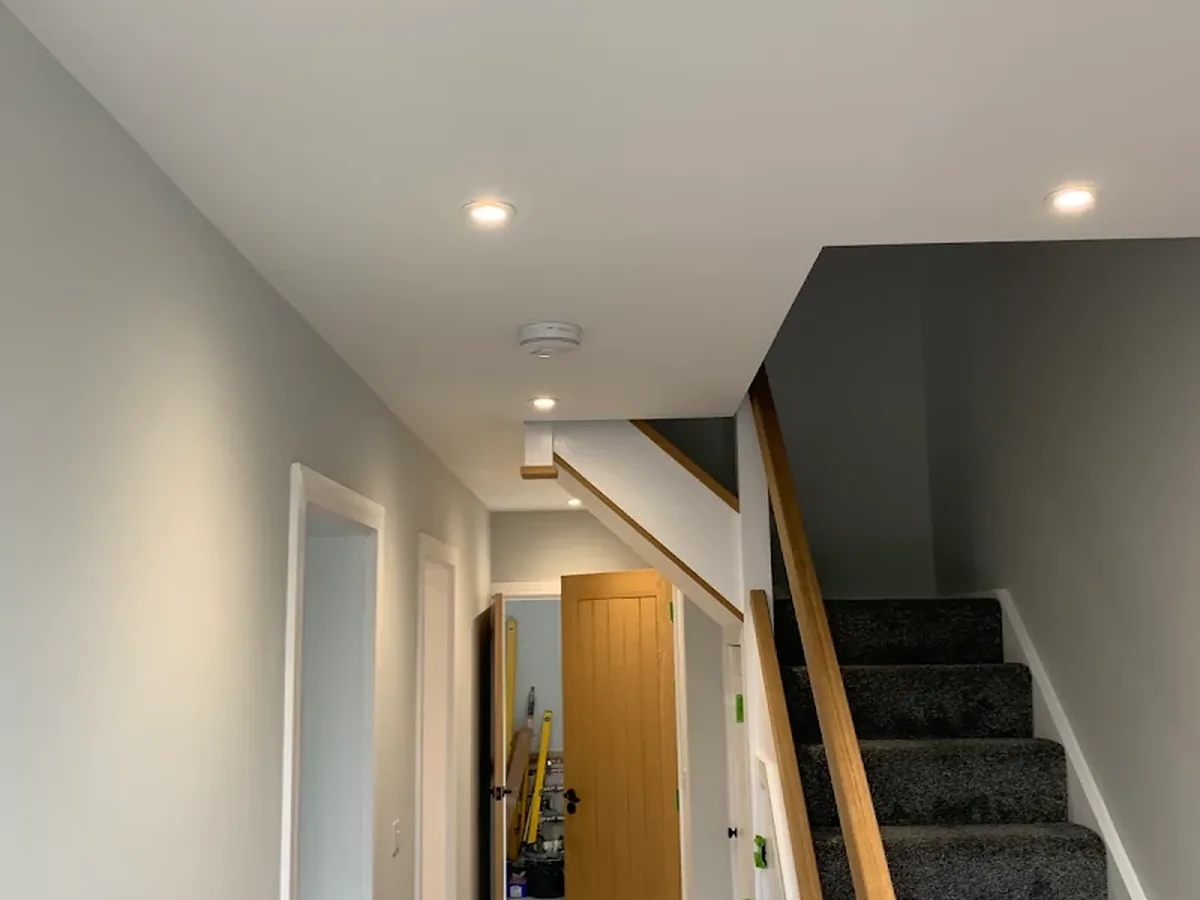 Hallway and staircase with recessed downlights after a full rewire