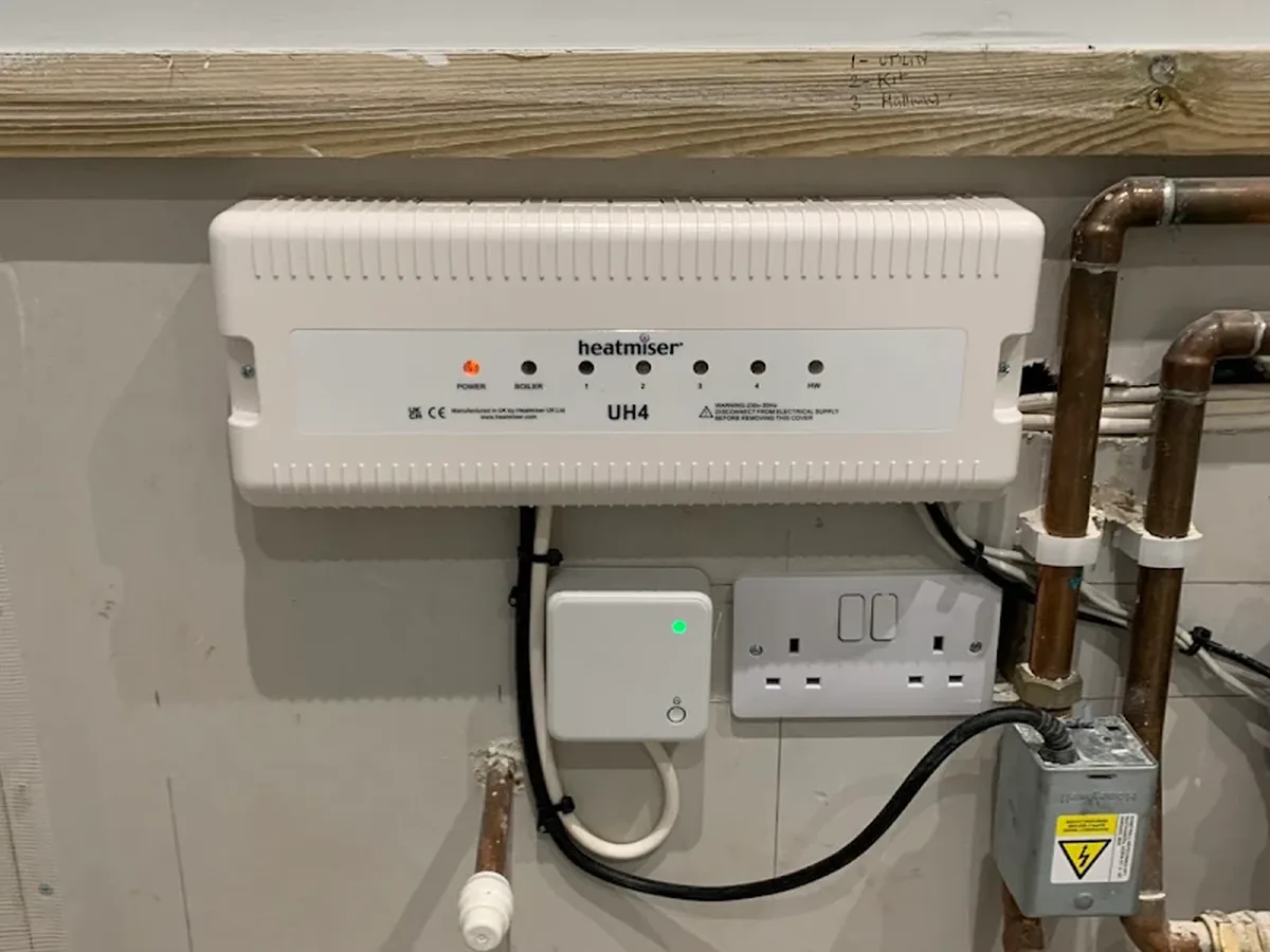 Heatmiser underfloor heating wiring centre installed alongside copper pipework