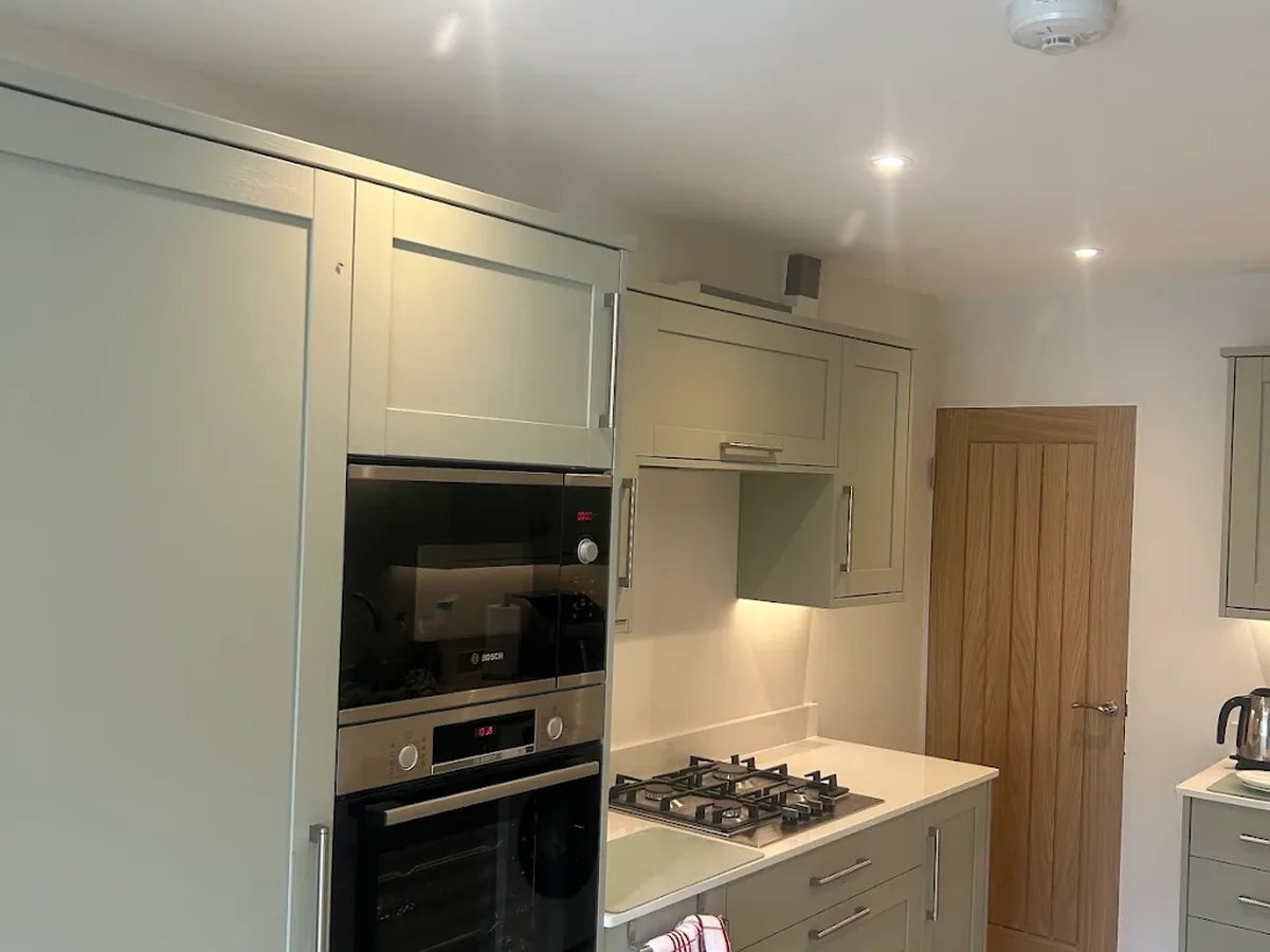 Completed kitchen with recessed downlights and under-cabinet lighting