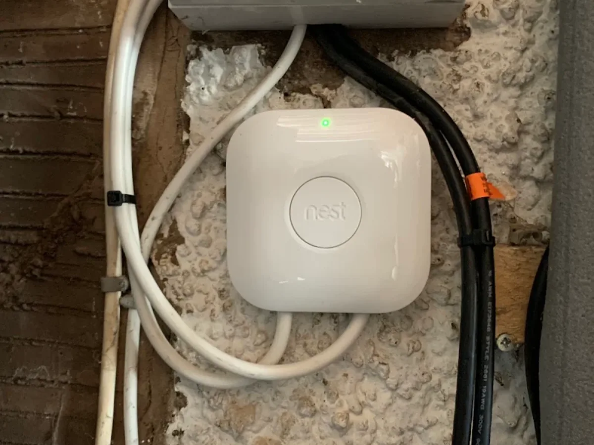 Smart heating control unit installed externally beside a weatherproof junction box